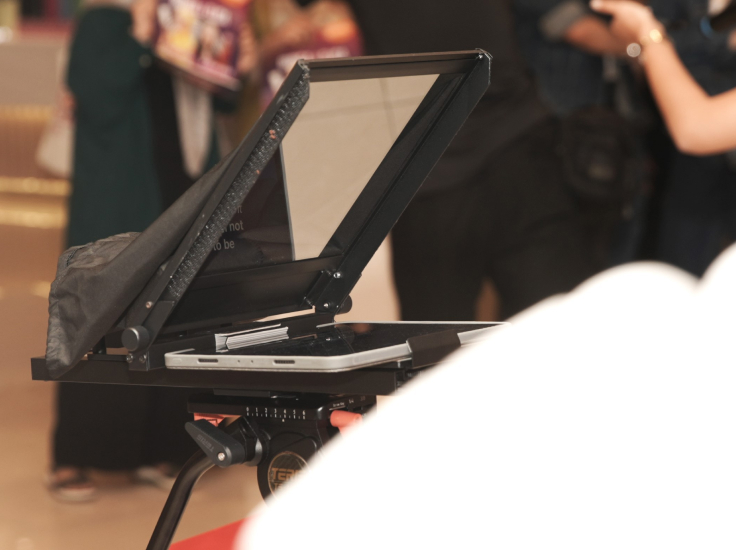 Close-up of a professional iPad teleprompter setup mounted on a tripod.