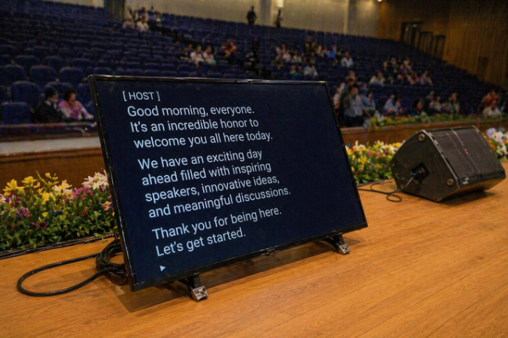Stage monitor teleprompter in use at a live event.